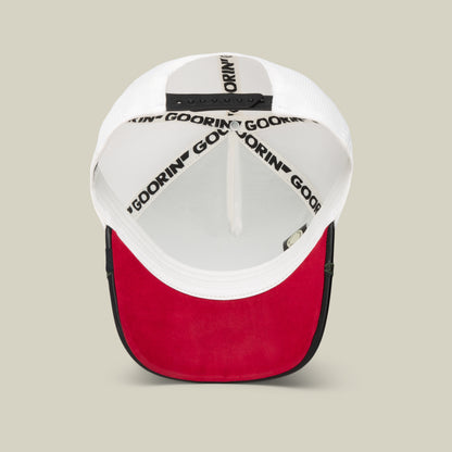 A red and white Amor baseball cap from Goorin Bros. shown from the underside, featuring a black adjustable strap and branded interior seams—ideal to pair with your favorite jewelry for a laid-back Friday look.