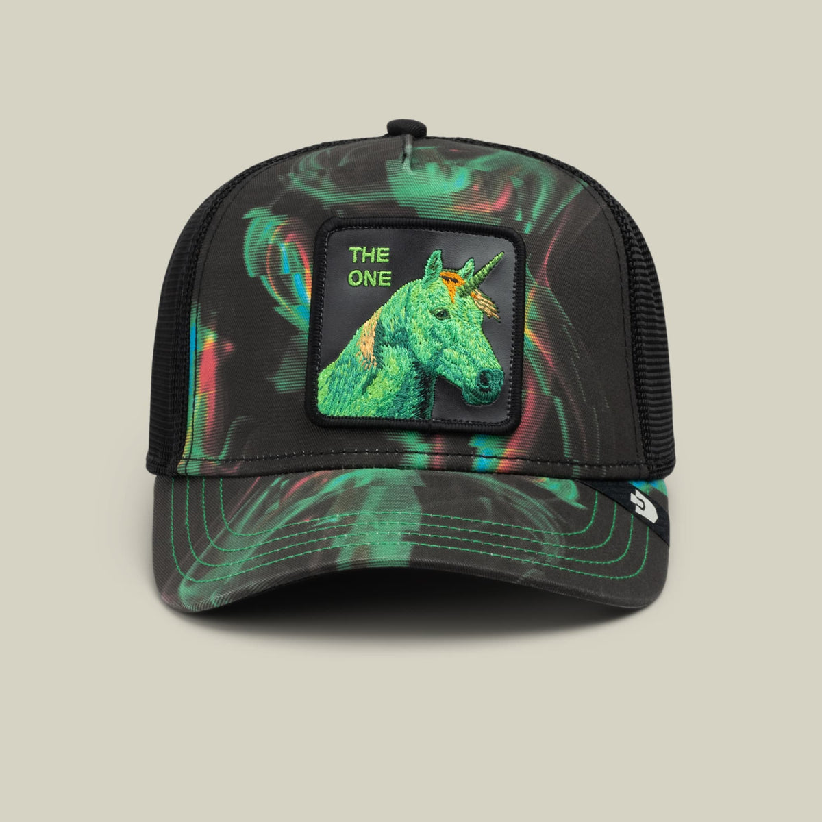 The Goorin Bros. No Spoon trucker hat features a black mesh back, holographic neon green swirled front panel, and a embroidered unicorn patch with "The One" text against a neutral studio background.