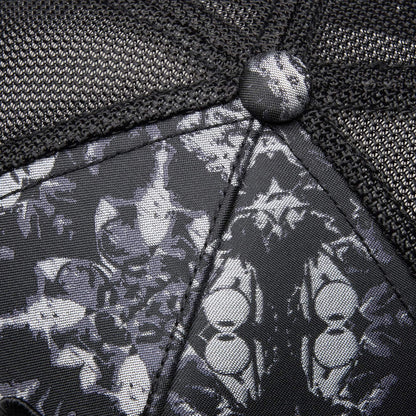 Close-up of Goorin Bros. "Gray Matter" hat—black mesh and fabric with a monochrome pattern of stylized cat faces, playfully hinting at the clever gray matter within.
