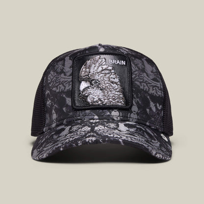 The Gray Matter hat by Goorin Bros. in VOID features black mesh, a monochrome bird pattern, and a front patch with a bird head and "BRAIN"—an ideal trucker cap to showcase your unique style.