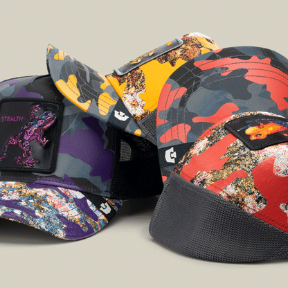 Four colorful "Knight in Sliming Armor" baseball caps by Goorin Bros., each with bold Hero patch or dino design, are displayed against a neutral background.