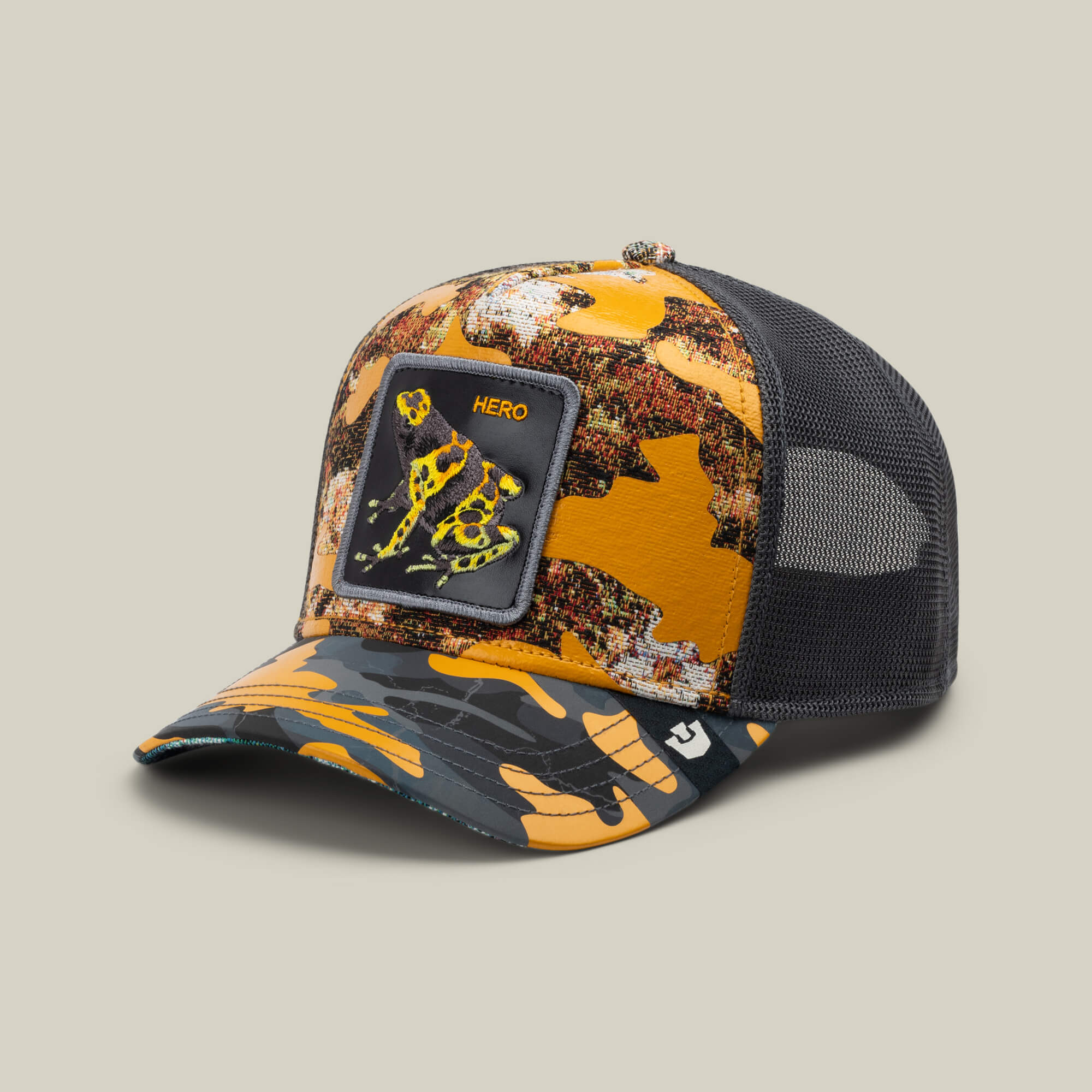 The Knight in Sliming Armor by Goorin Bros. is a golden camo trucker hat with mesh back, featuring a stylized robotic dog Hero patch, inspired by the Yellow Swamp Battalion with bold yellow, orange, and black accents.