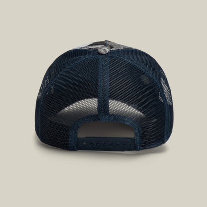 Rear view of the Goorin Bros. Bone Head Danger hat in navy blue, featuring a mesh back and adjustable plastic snap closure, displayed on a plain light beige background.