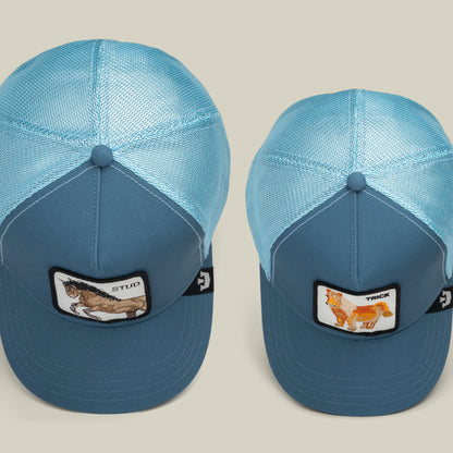 The Goorin Bros. “Dad and Pony Show” set includes two blue trucker hats with mesh backs—one featuring a STUD wolf patch, the other a TRICK fox patch—ideal matching Father’s Day caps for dads and kids.
