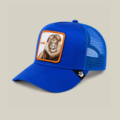 The Empire State of Mind cap by Goorin Bros. features blue mesh panels and a KING lion patch on the front. Shown on a beige background. Pre-order yours now!.