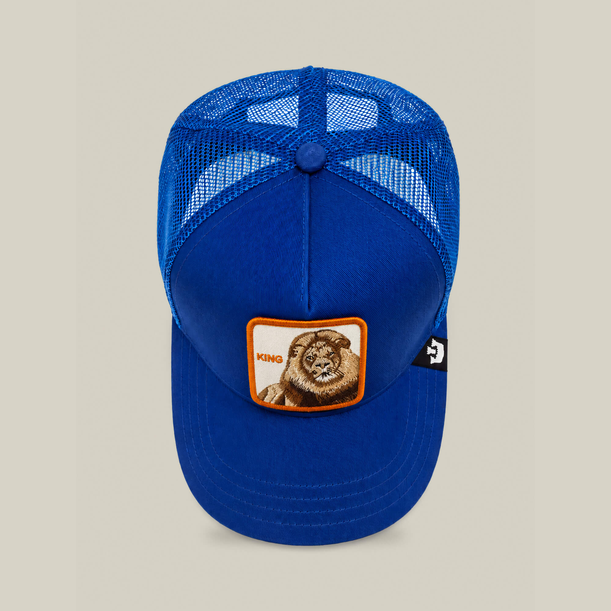 The Goorin Bros. "Empire State of Mind" blue mesh trucker hat features a front patch with a lion and KING in orange text—perfect for bold style.