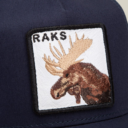 Close-up of the Goorin Bros. limited-edition Rakell Moose cap in navy blue, featuring a rectangular patch embroidered with a moose head and "RAKS" text—exclusive to Rickard Rakell fans.