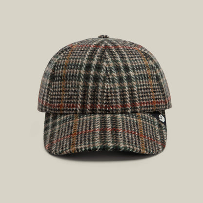 A front view of the Goorin Bros. Cozy Tailored Baseball cap in PALM, featuring a classic six-panel plaid wool design with green, brown, and red tones, finished with a small black tag on the left side.