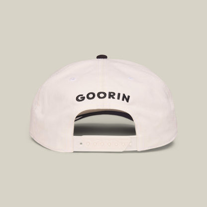 The Mildly Remarkable Script by Goorin Bros. is a white Low Pro Fit cap seen from the back, featuring classic "GOORIN" script embroidery above an adjustable plastic strap for a timeless and comfortable style.