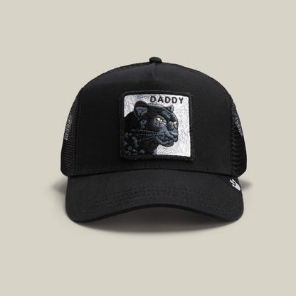 The Goorin Bros. Daddy Panther in black is a mesh trucker hat with a front patch featuring an embroidered platinum panther and the word DADDY—an essential accessory for standout style.