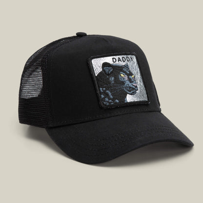 The Daddy Panther trucker hat by Goorin Bros. features black mesh, a front patch with a platinum panther and the word "DADDY," all displayed on a neutral background—your top-shelf accessory for standout style.
