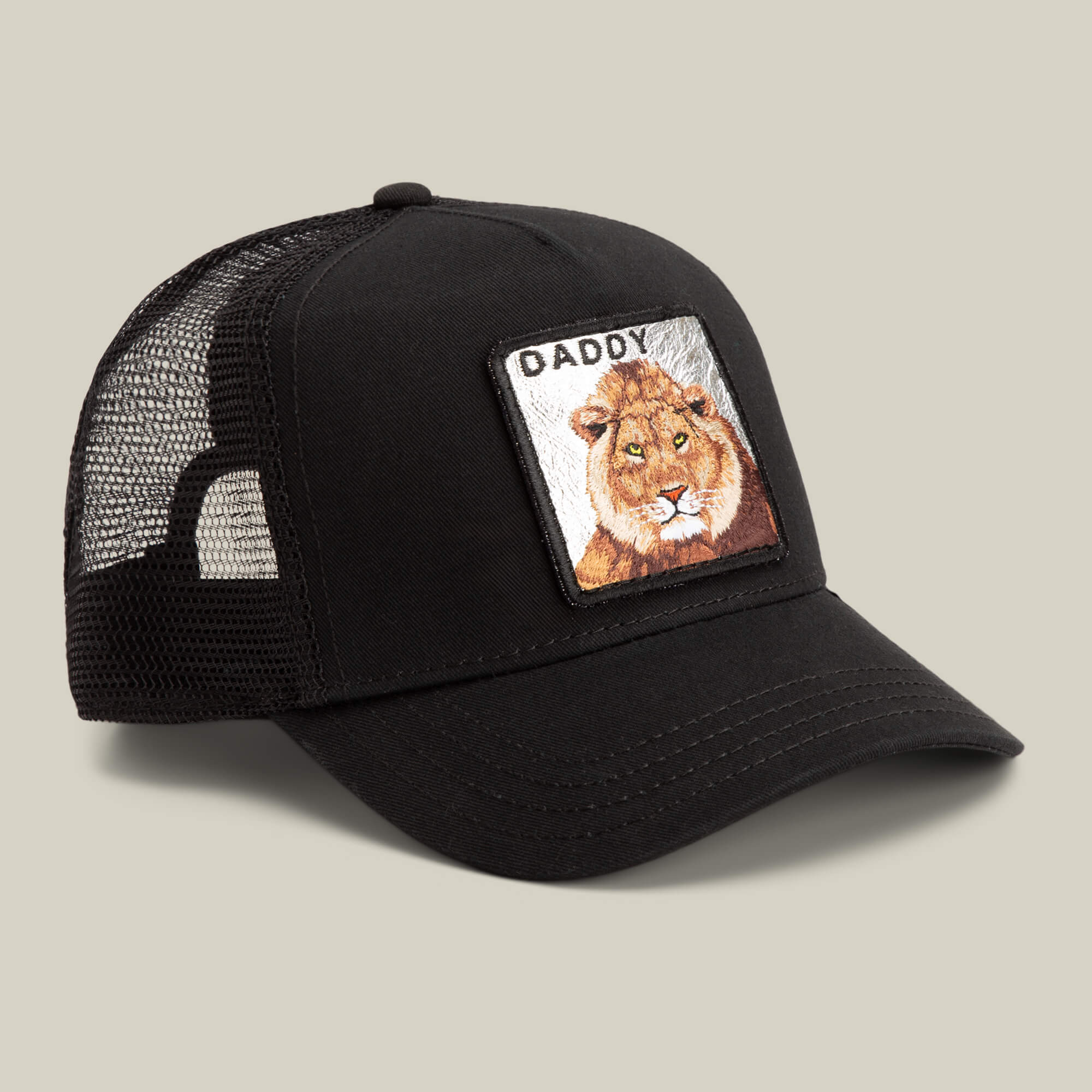 The Daddy King by Goorin Bros. is a limited edition black mesh trucker hat featuring a front patch with an illustrated lion and "King Daddy" above it, shown on a neutral background.