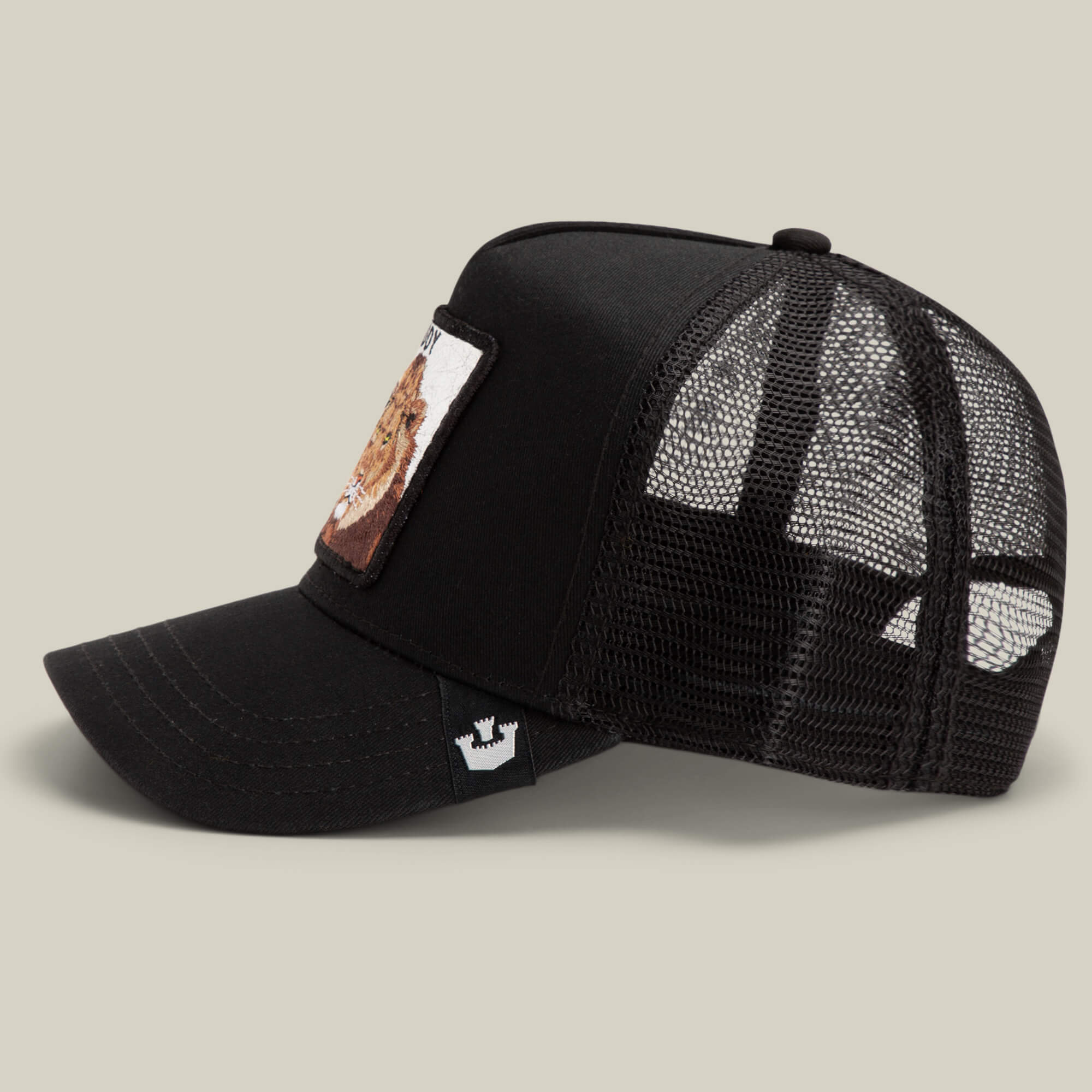 The Goorin Bros. Daddy King black mesh trucker cap features a curved brim and a Limited Edition animal patch on the front panel, displayed in side profile on a neutral background.