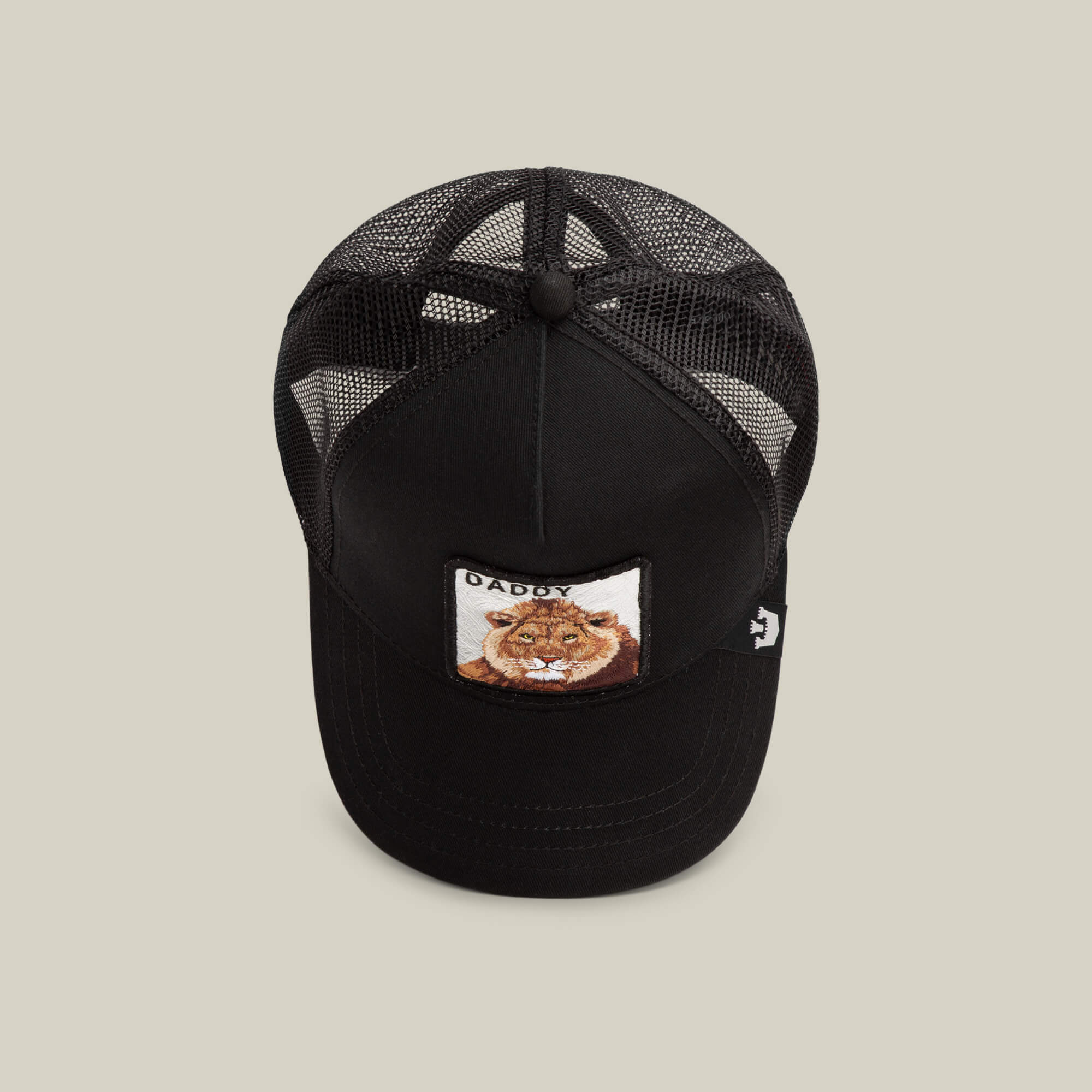 The Daddy King by Goorin Bros. is a black mesh trucker hat with a front patch featuring a lion face and "King Daddy" text. This limited edition accessory adds bold style to any outfit.