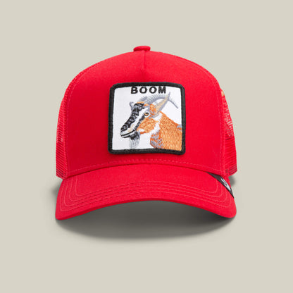 The Goorin Bros. Dave Scott Boom Goat is a red mesh trucker hat with a front patch featuring an embroidered antelope and the word "BOOM" above it.