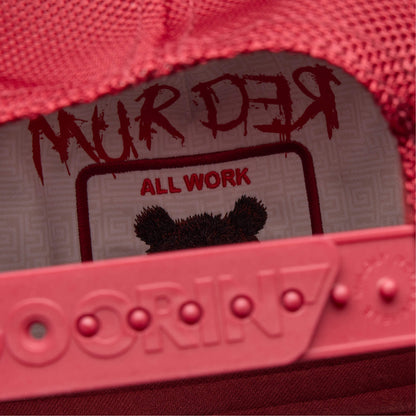 Close-up of a red Dull Boi shoe by Goorin Bros., featuring "MURDER above ALL WORK" and an illustration of Johnny the bear’s head on the insole.