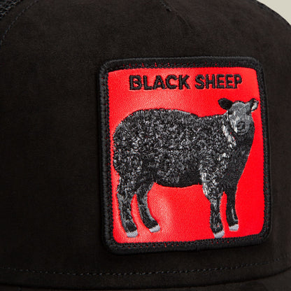 The Goorin Bros. Pecora Nera Rossa is a black trucker hat featuring a red embroidered patch with a black sheep graphic and text on the front panel, shown in a close-up studio shot.