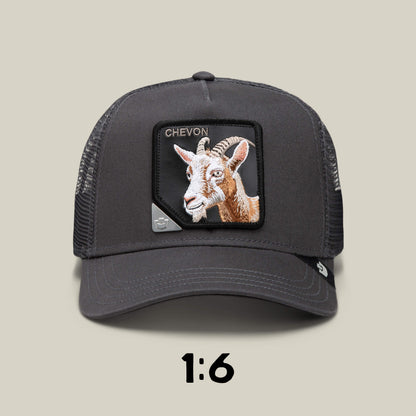 The Goorin Bros. "Blind Box 1: U R WUT U EET" is a black mesh trucker hat featuring a goat patch with CHEVON above it, displayed on a beige background with "1:6" below—a unique mystery animal hat from the blind box collection.