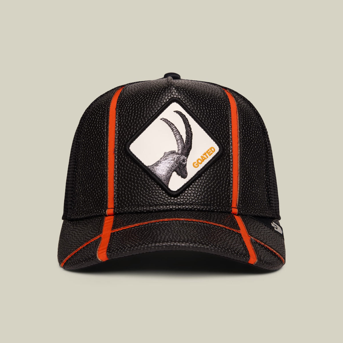 The Goorin Bros. Know Ball trucker hat features black mesh fabric with bright orange piping, a goat patch on the front, and a structured six-panel design displayed on a neutral background.