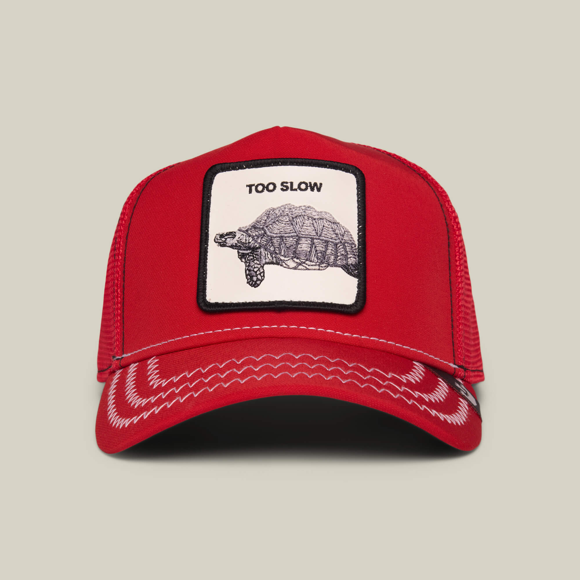 The Down Low... trucker cap by Goorin Bros. in Rush Red features a white patch with a turtle illustration and "TOO SLOW" above it—a standout piece from an elusive drop.