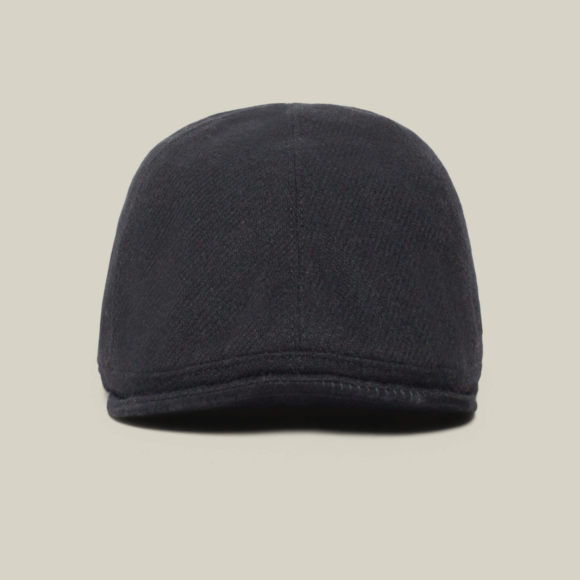 A front view of the dark-colored Ronald Amos six-panel cap by Goorin Bros., featuring a stylish brim, set against a plain, light background.