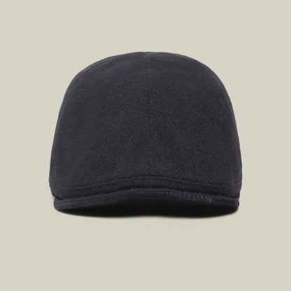 A front view of the dark-colored Ronald Amos six-panel cap by Goorin Bros., featuring a stylish brim, set against a plain, light background.