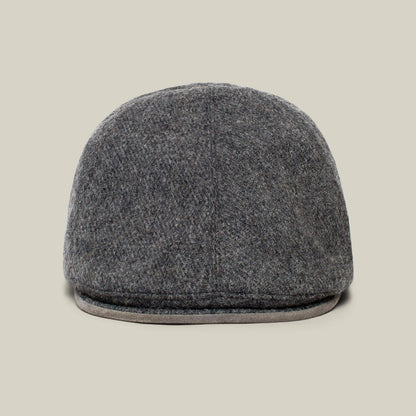The Ronald Amos cap by Goorin Bros. is displayed from the front against a beige background, showcasing its stylish brim and classic six-panel grey wool design—ideal for everyday wear.