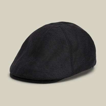 An ebony “Benjamin Paul” flat cap by Goorin Bros., crafted from fabric and ideal for everyday wear, displayed on a plain light beige background.
