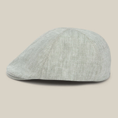The Benjamin Paul flat cap by Goorin Bros. features textured light gray linen and is shown from the side against a plain beige background.