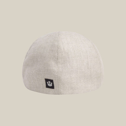 The Benjamin Paul linen hat by Goorin Bros. features a light beige shade and a small black rectangular logo tag on the back—ideal for everyday wear, shown against a plain beige background.