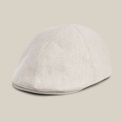 The Benjamin Paul hat by Goorin Bros., in light beige textured linen, is shown on a neutral background from a front side angle.