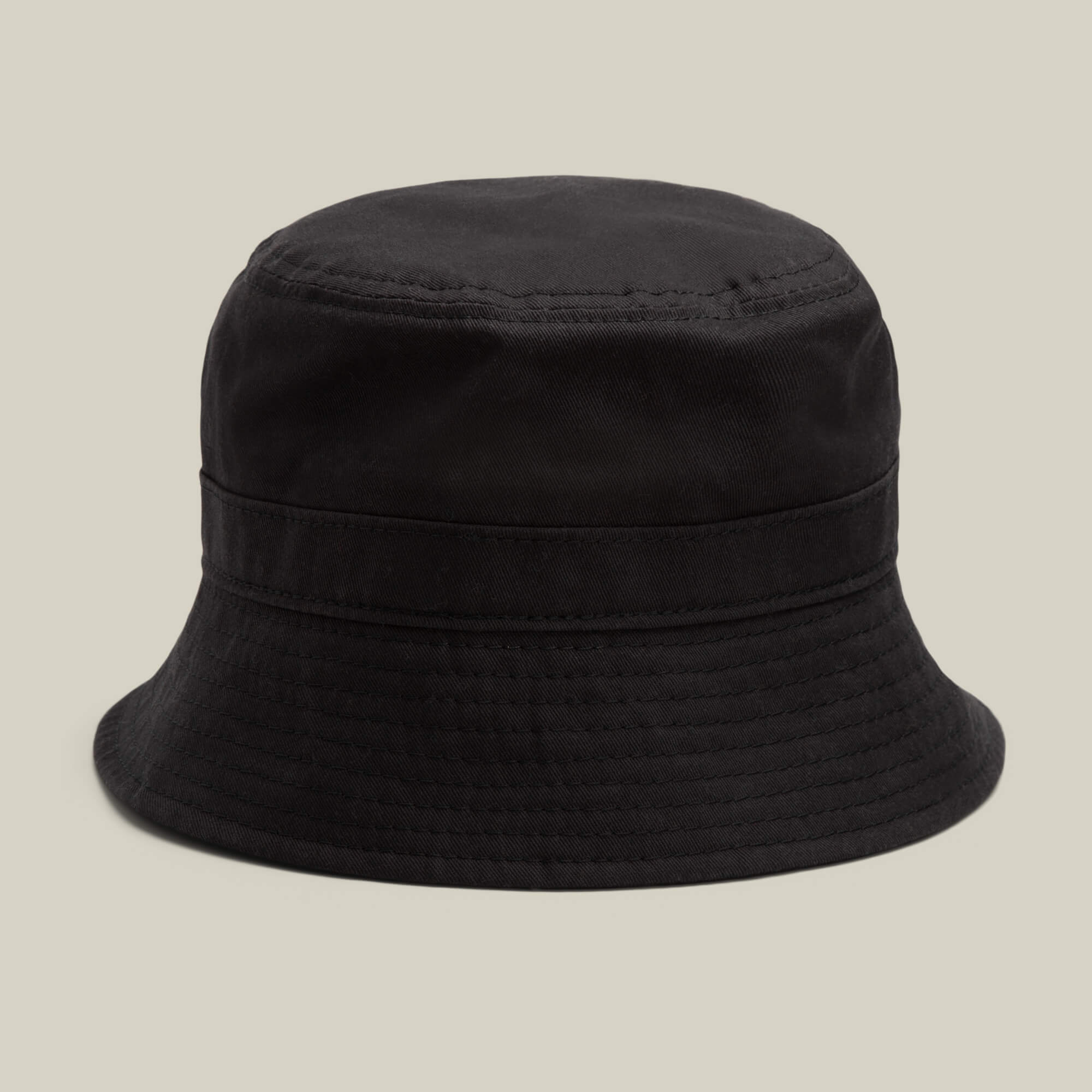 A Goorin Bros. Odyssey Bucket hat in VOID, crafted from black cotton fabric, displayed against a neutral beige background.