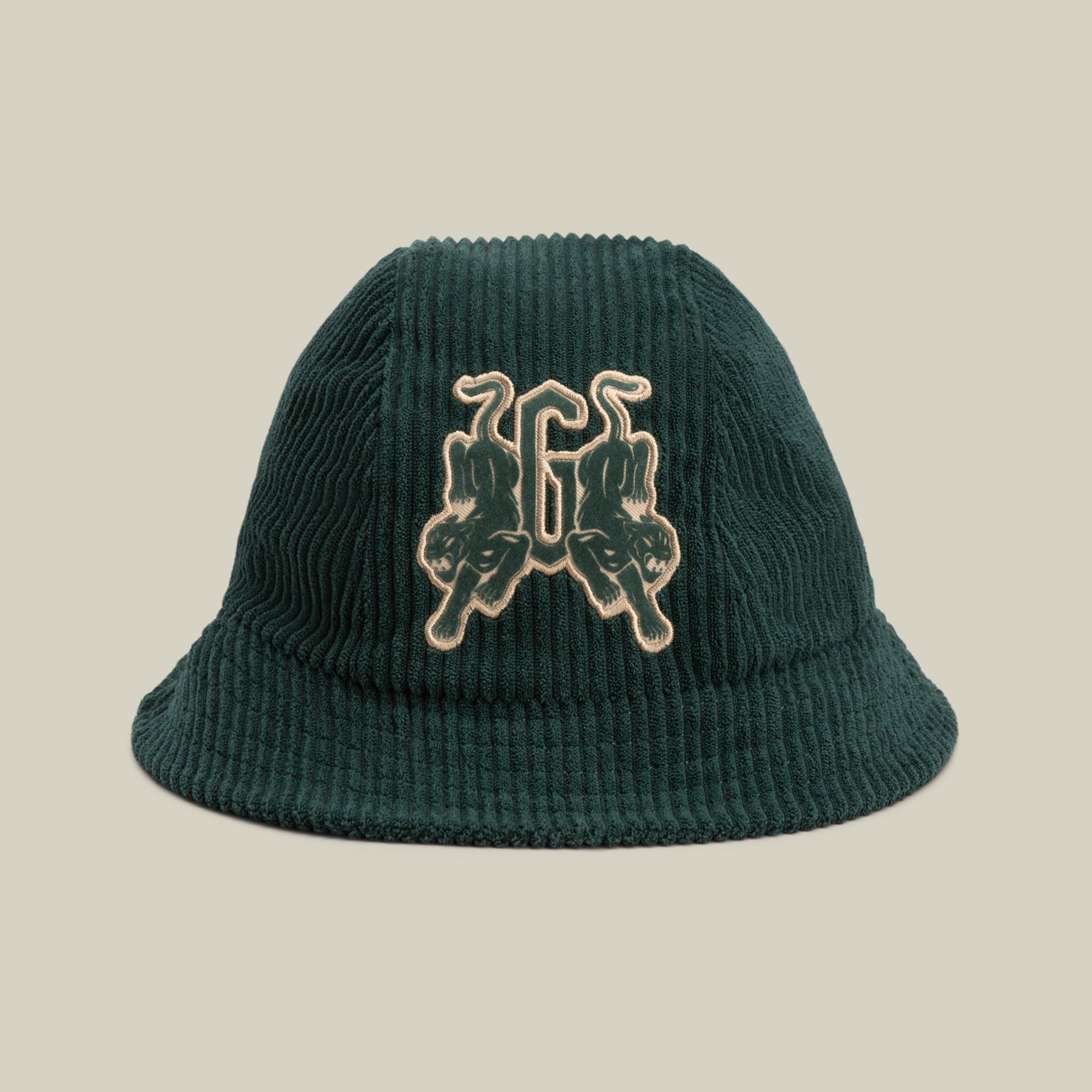 The Yes Coach bucket hat by Goorin Bros. is a dark green corduroy cap with subtle navy ribs, featuring an embroidered patch of twin upside-down panthers and the number 66 on the front.