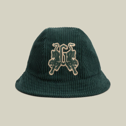 The Yes Coach bucket hat by Goorin Bros. is a dark green corduroy cap with subtle navy ribs, featuring an embroidered patch of twin upside-down panthers and the number 66 on the front.