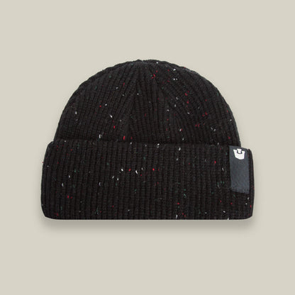 The Goorin Bros. No Comply beanie in black ribbed knit features subtle multicolored specks and a folded cuff with a small rectangular logo patch on the right side.