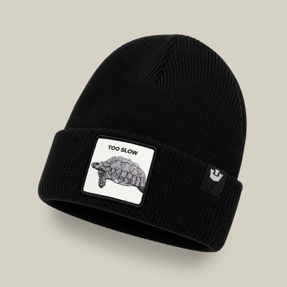 The Goorin Bros. Darn Low is a black knit beanie cap featuring a sewn patch with a turtle illustration and the text “TOO SLOW”—a true badge of honor for anyone who moves at their own pace. An additional black tag with the white Goorin Bros. logo adds a final touch, making this accessory as coveted as any elusive drop.
