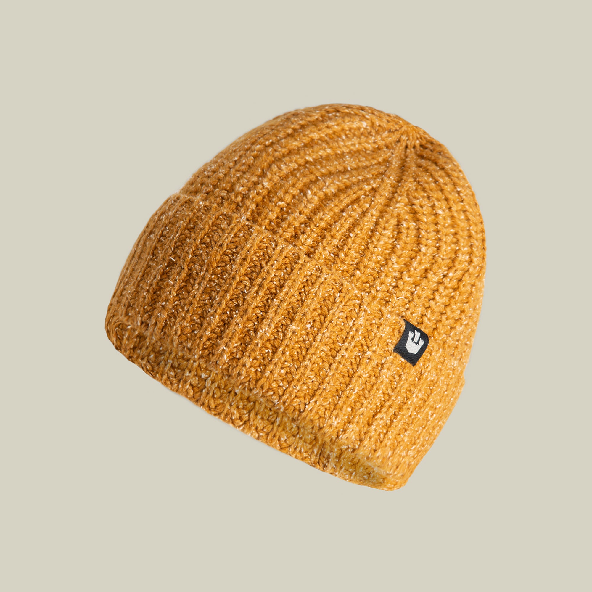 The Goorin Bros. Northstar beanie in Whiskey features a ribbed knit texture, soft merino wool construction, and a small black rectangular logo patch on the side, shown against a plain beige background.