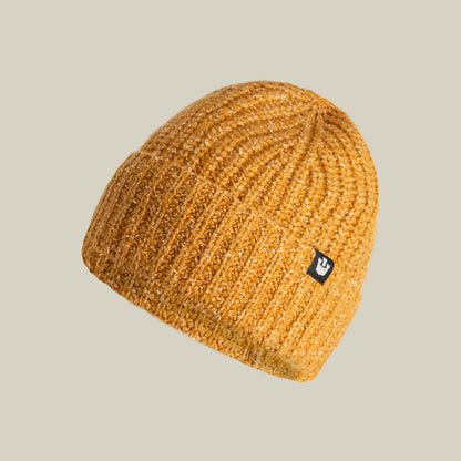 The Goorin Bros. Northstar beanie in Whiskey features a ribbed knit texture, soft merino wool construction, and a small black rectangular logo patch on the side, shown against a plain beige background.