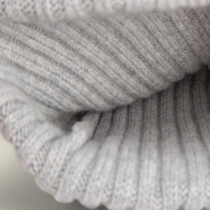 Close-up of the luxurious, light gray ribbed knit texture of the Dream Cap by Goorin Bros., highlighting its fine stitching and soft cashmere wool.