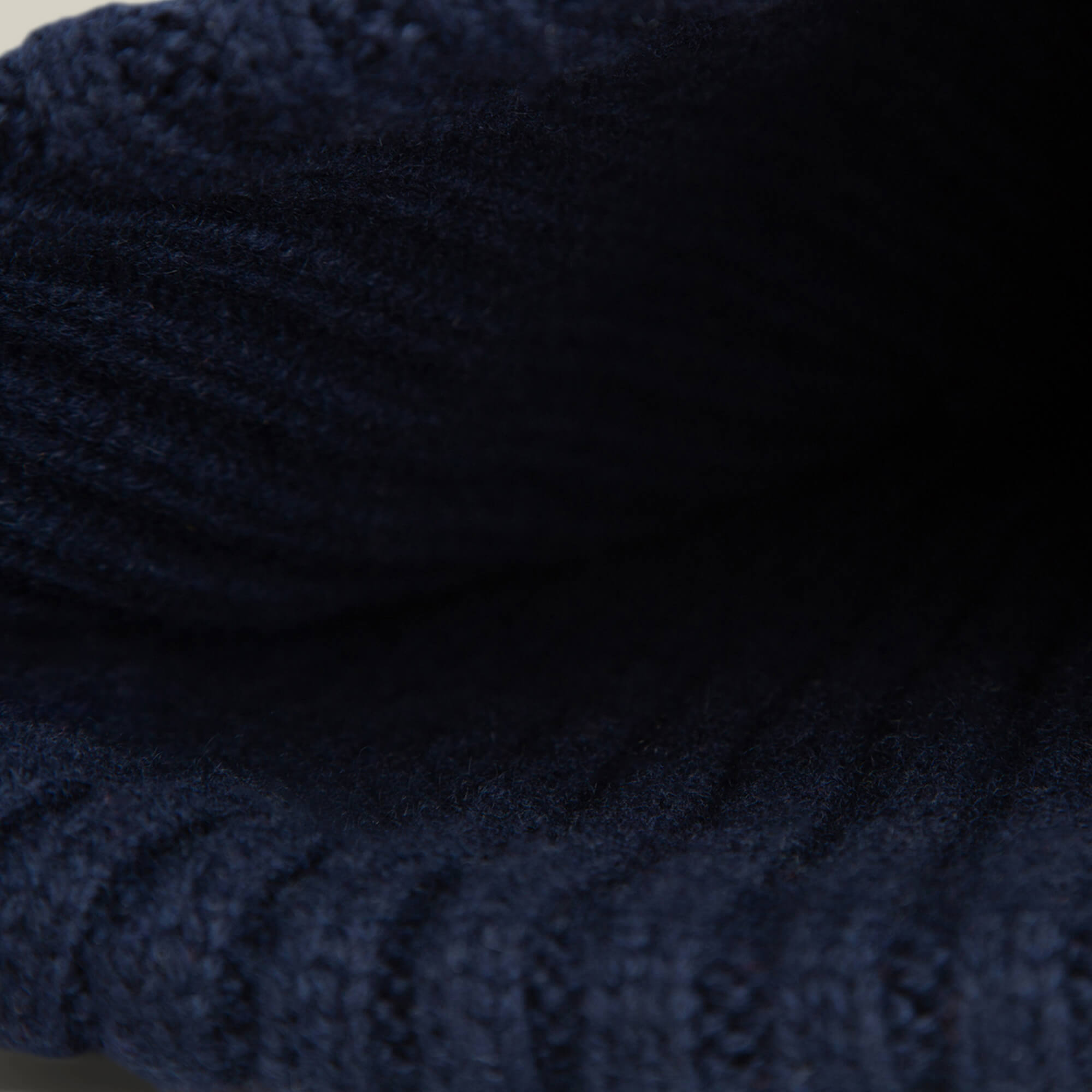 Close-up view of the dark blue ribbed knit fabric on the Dream Cap by Goorin Bros., showing its likely soft and luxurious interior.