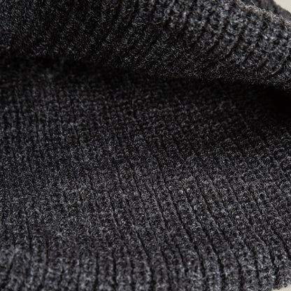 Close-up view of the black ribbed knit fabric from The Black Panther Beanie by Goorin Bros., highlighting its detailed texture and stitching pattern.
