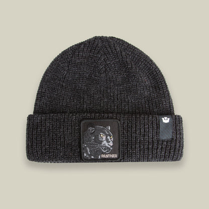 The Black Panther Beanie by Goorin Bros. in VOID features a warm knit design with a folded brim, a bold panther patch, and the word "PANTHER" on the front.