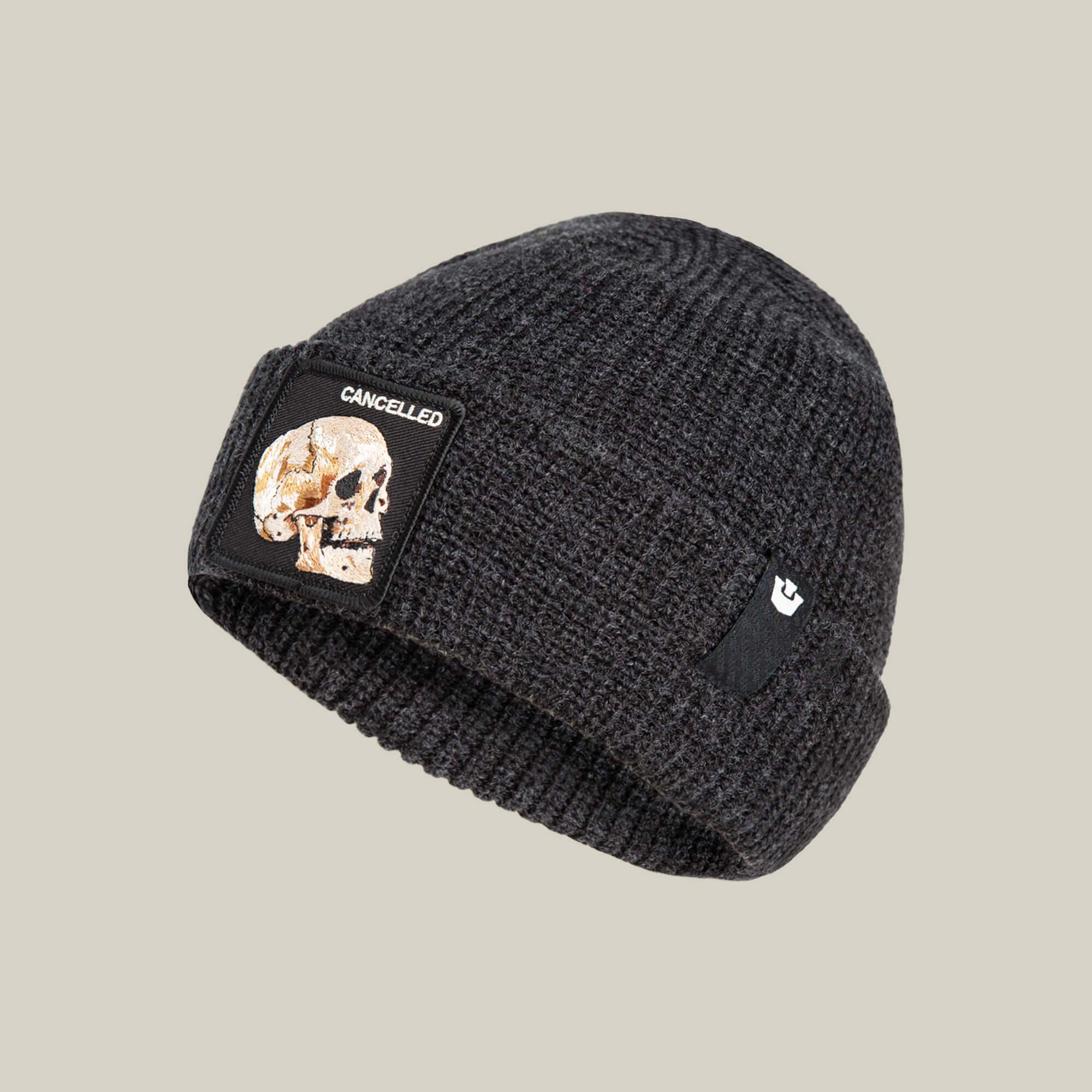The Cancelled Beanie by Goorin Bros. is a charcoal knit cuff hat featuring a skull patch and “CANCELLED” on the front—ideal for fans of dark humor.