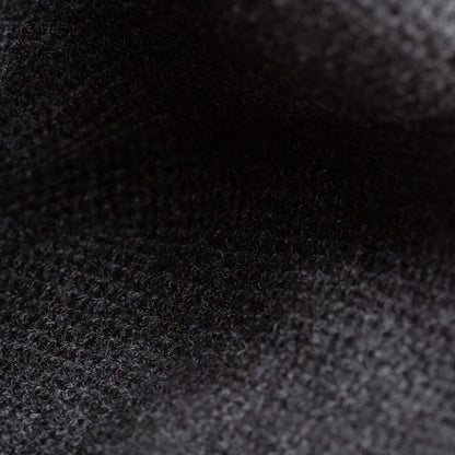 Close-up of The Deadly Beanie by Goorin Bros.—a dark, textured knit with a slightly fuzzy surface and visible weave, making it perfect for winter.