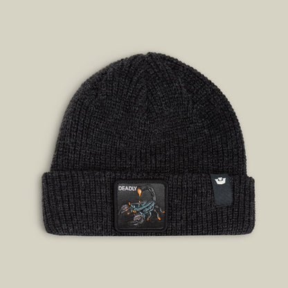 The Deadly Beanie by Goorin Bros. in VOID features cozy knitwear, a bold scorpion patch with "DEADLY," and a white logo tag on the cuff, shown against a plain light background.