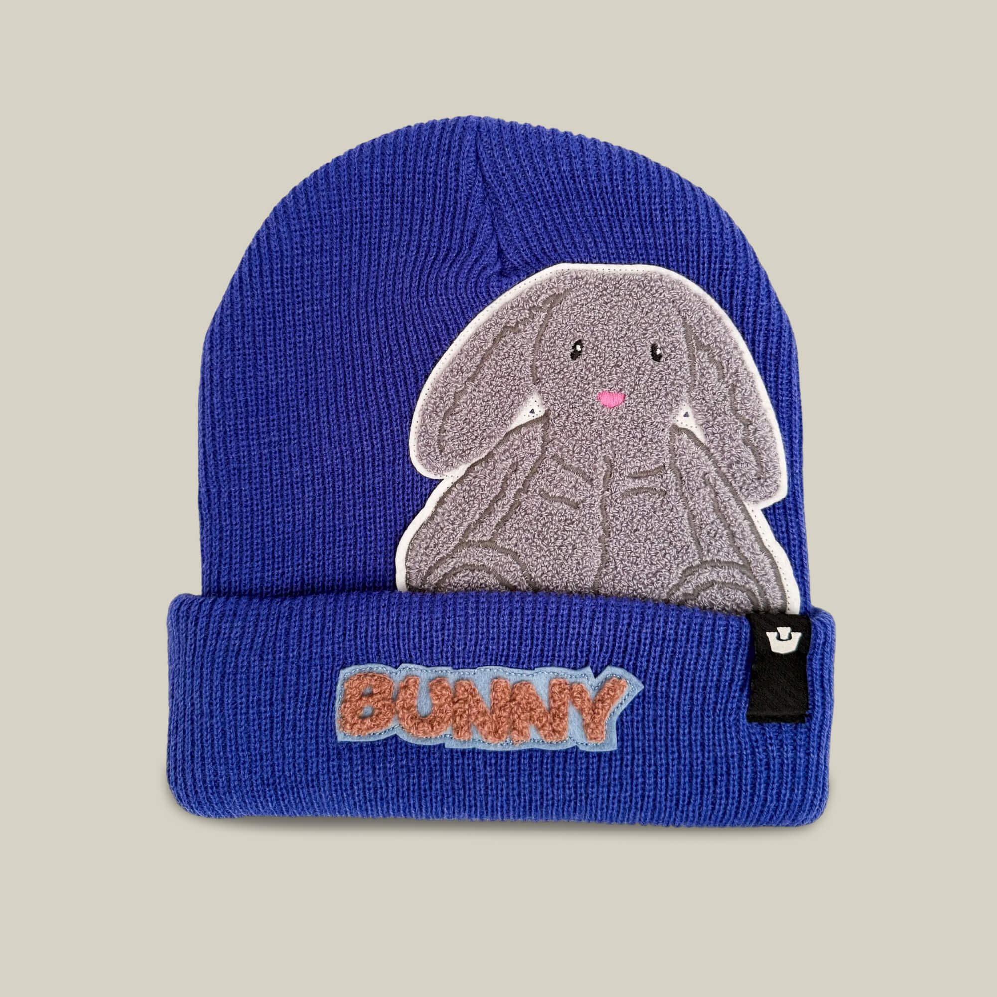 Introducing the Double Stuffed - Bunny Beanie - big by Goorin Bros., a heavyweight knit beanie in Luster, featuring a gray bunny patch and the word “BUNNY” embroidered in orange on the folded brim—perfect for double-stuffed warmth on chilly days.