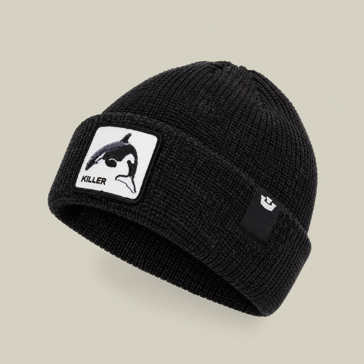 The Killer Whale Beanie by Goorin Bros is a black ribbed knit beanie with a white patch featuring a killer whale illustration and the word "KILLER" displayed on the front against a neutral background.