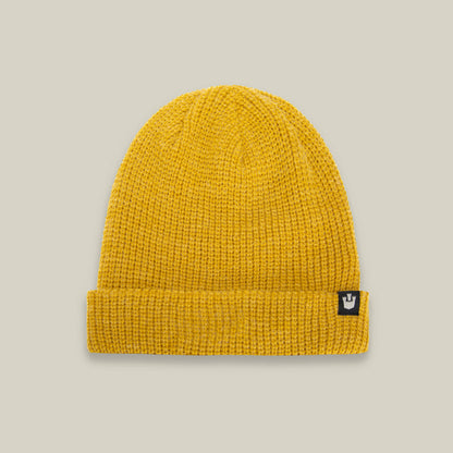 The Goorin Bros. Air to Fakie beanie in gold features a folded brim, lightweight poly knit for all-season comfort, and a small black patch with a white crown logo on the front.