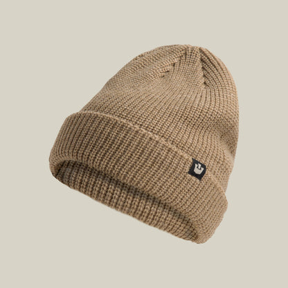 The Air to Fakie beanie by Goorin Bros. is a tan, lightweight poly knit hat with a folded brim and small black logo tag on the front, shown on a beige background—an ideal choice for all-season wear.