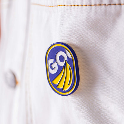 Add a playful touch to your white denim jacket with the GO Bananas Pin by Goorin Bros.—a glossy blue, yellow, and white enamel accessory featuring the word “GO!”.